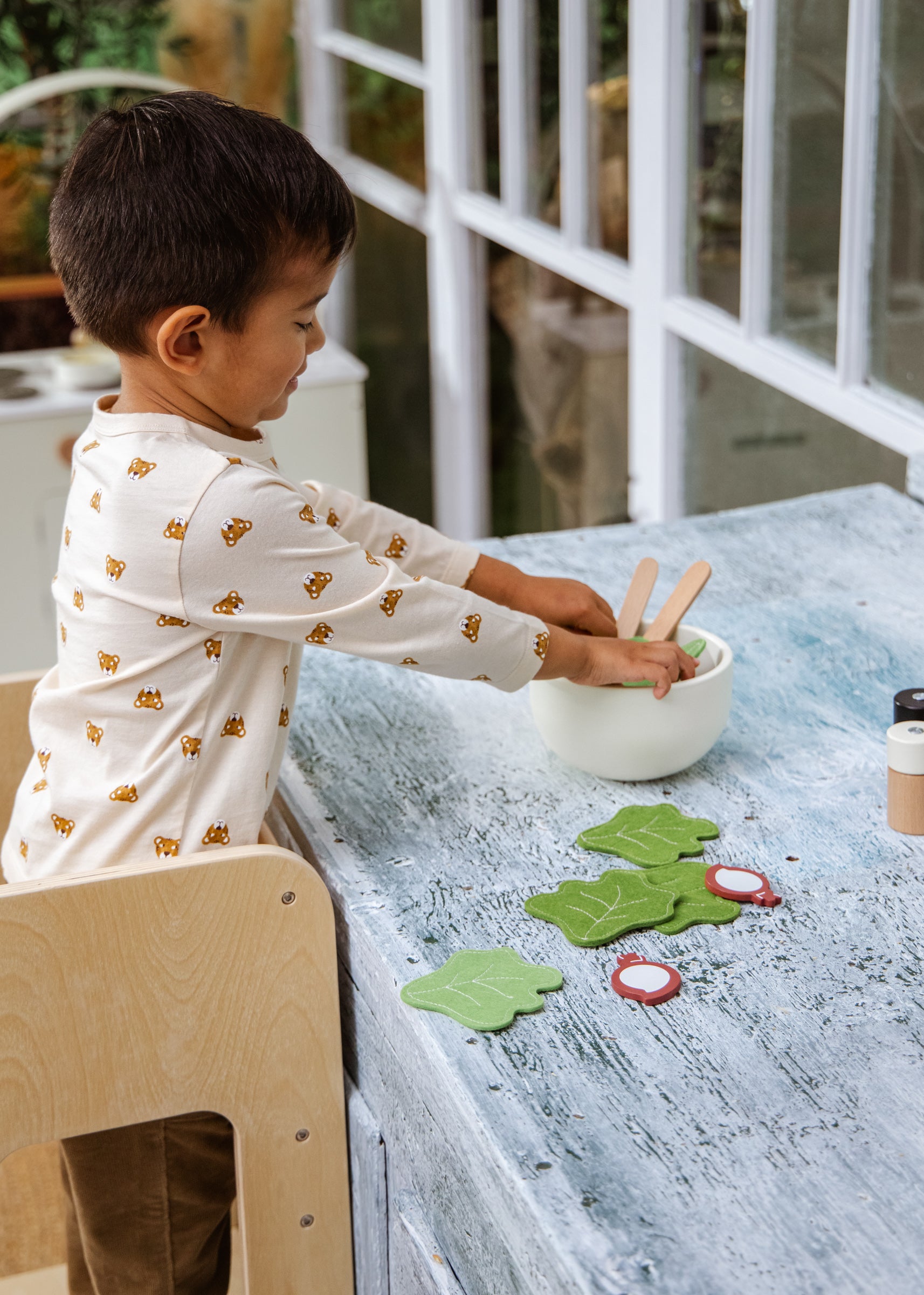 Child playing with toys at a table in a home setting