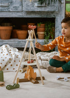 Child playing with wooden toys in a cozy indoor setting
