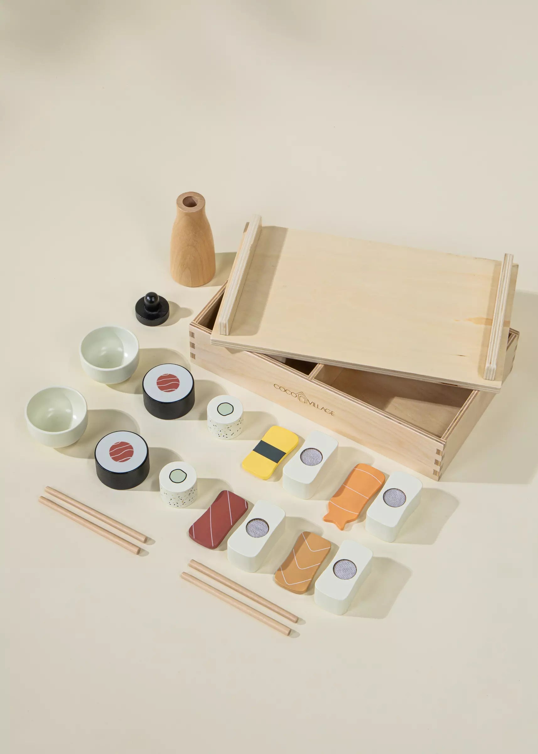 Wooden toy sushi set with a box on a beige background