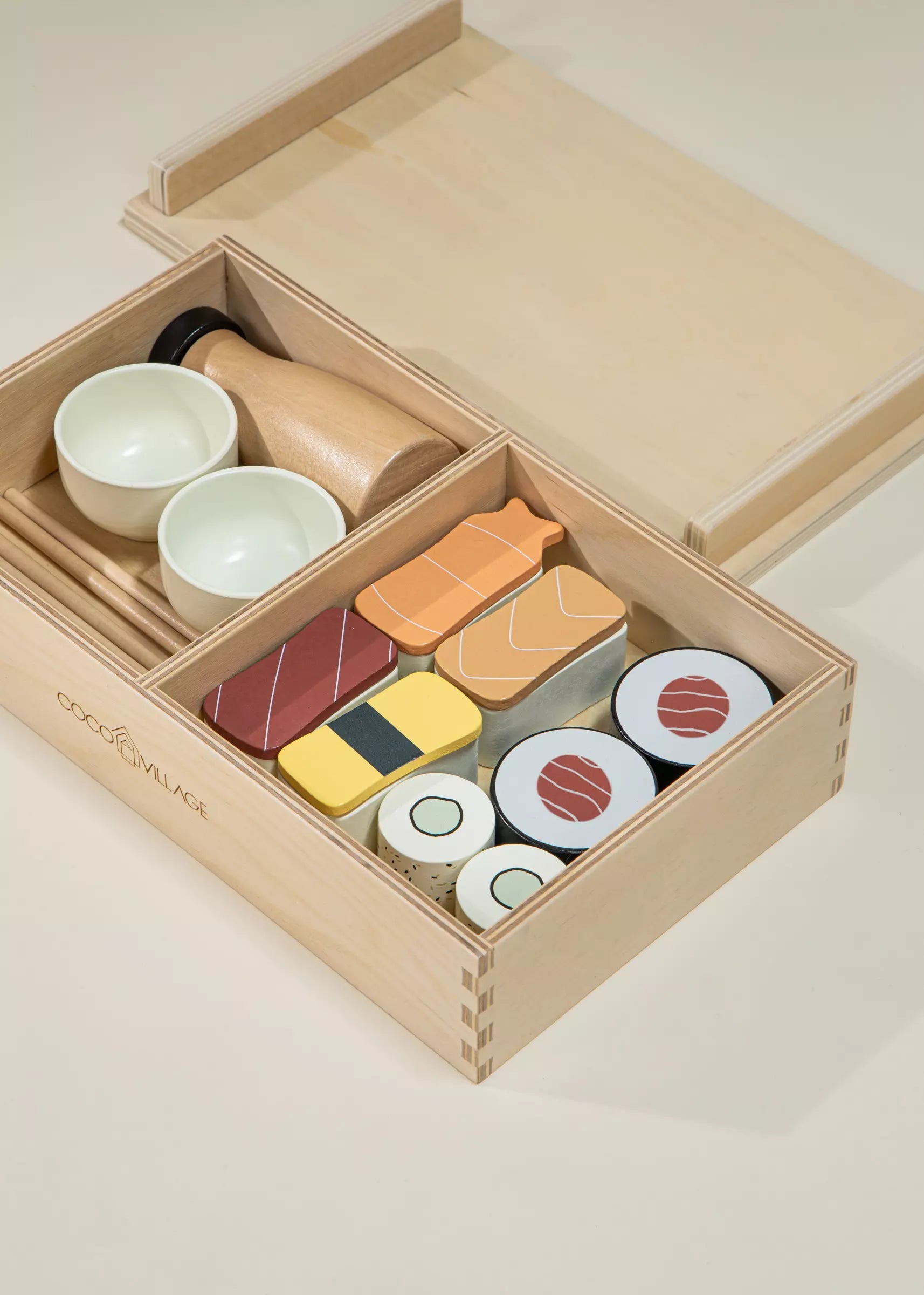 Wooden toy set resembling sushi in a box on a light background