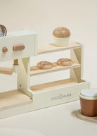 Wooden toy coffee shop set with shelves and coffee cups on a white background, branded 'Coco Village'.