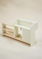 White and beige children's play kitchen set on a beige background