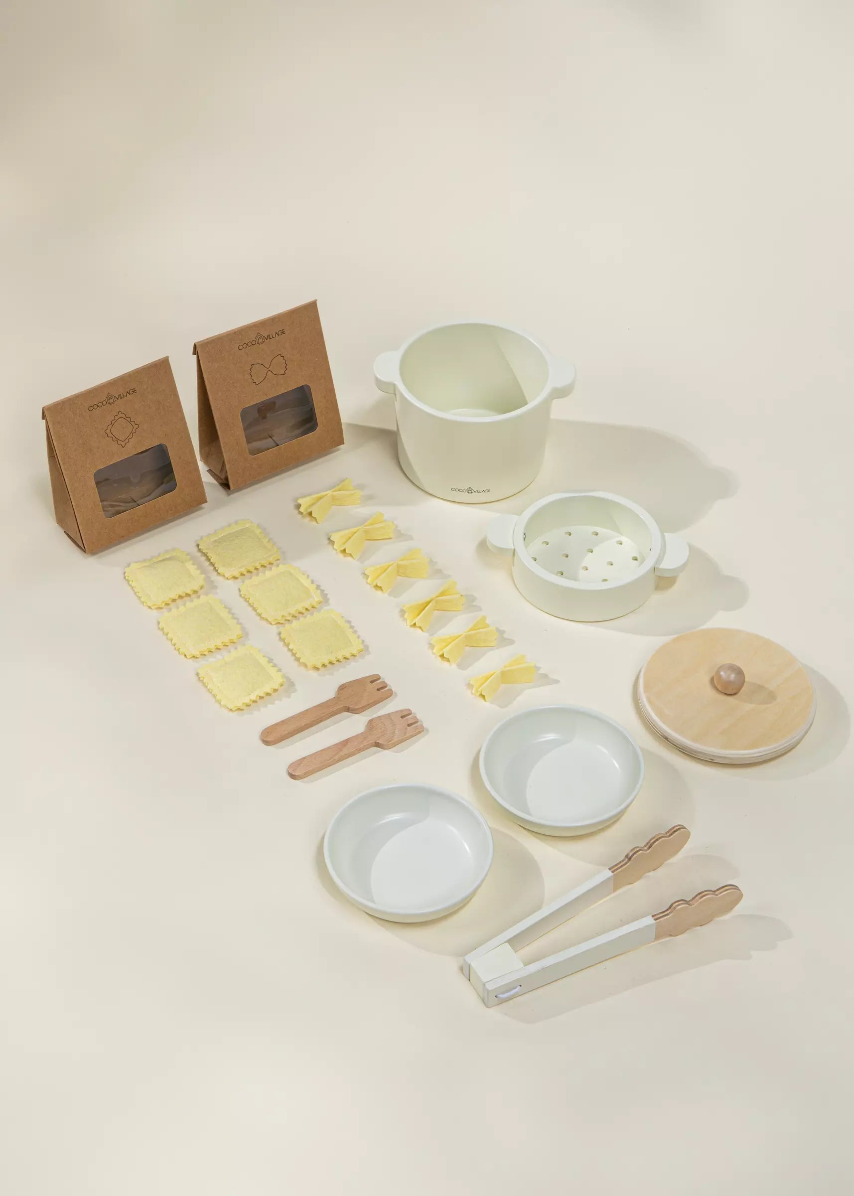 Set of wooden kitchen utensils and ceramic cookware on a light beige background