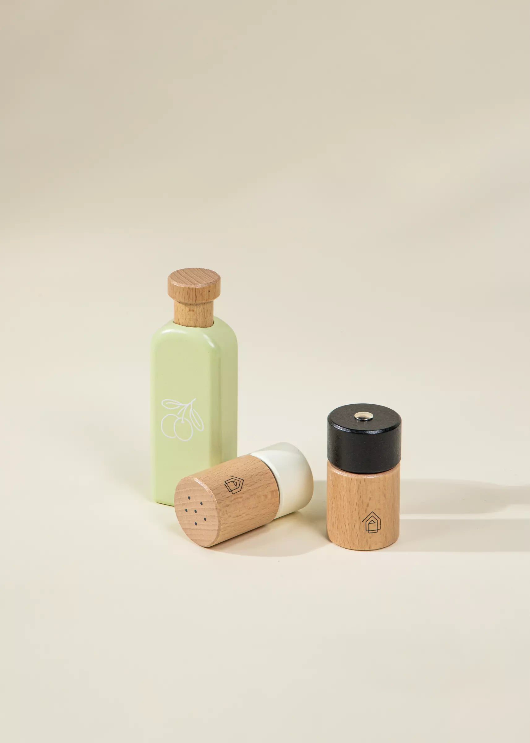 Set of three wooden containers with different finishes on a beige background