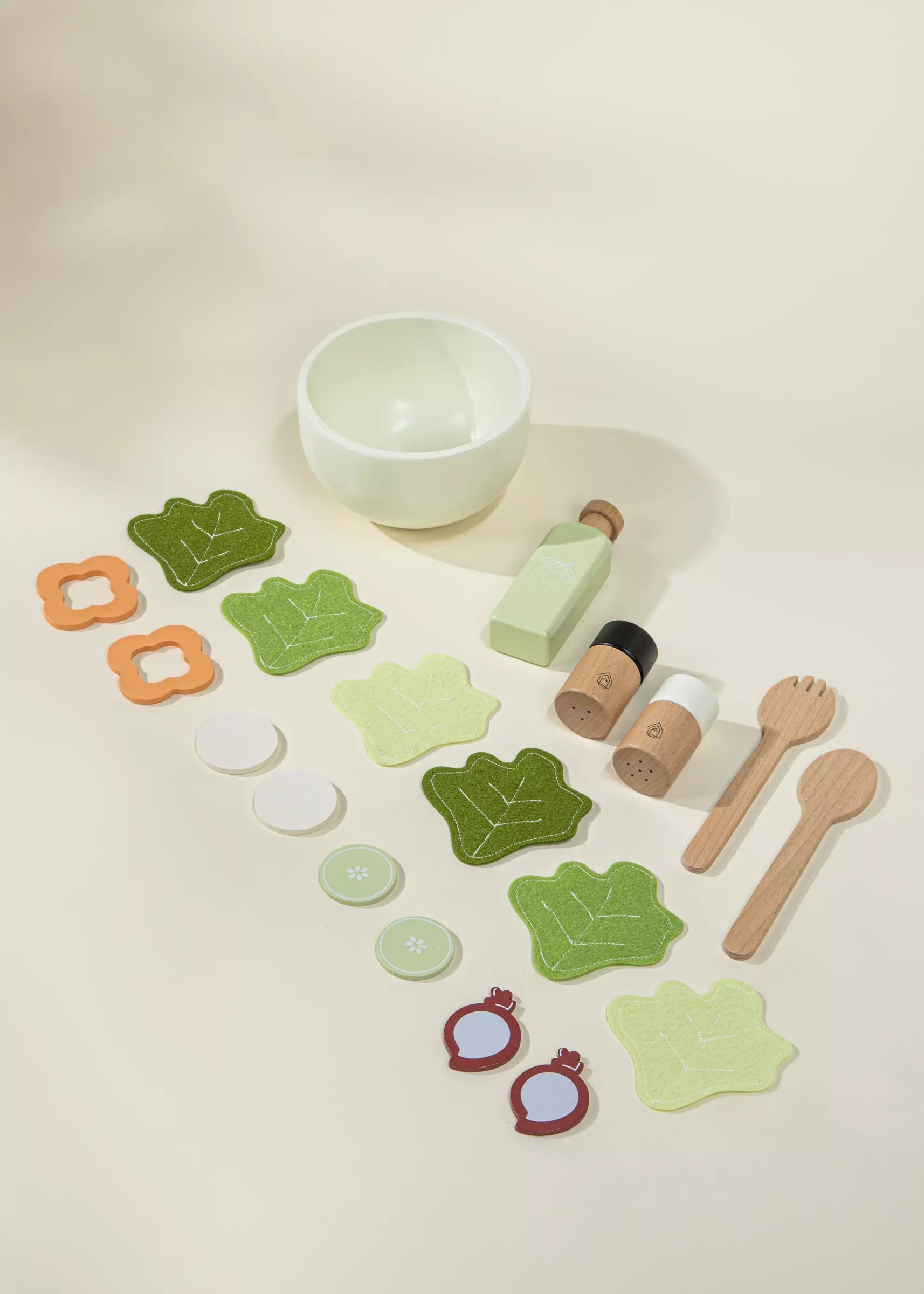 Set of wooden toys including a bowl, bottles, and various shapes on a light surface