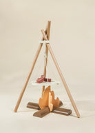Wooden teepee-like structure with shelves on a beige background