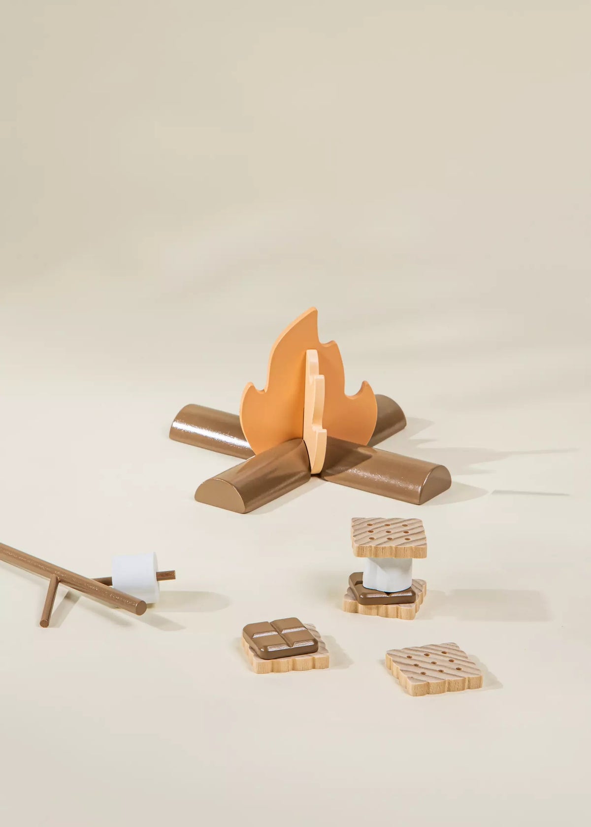 Wooden toy campfire set on a beige background