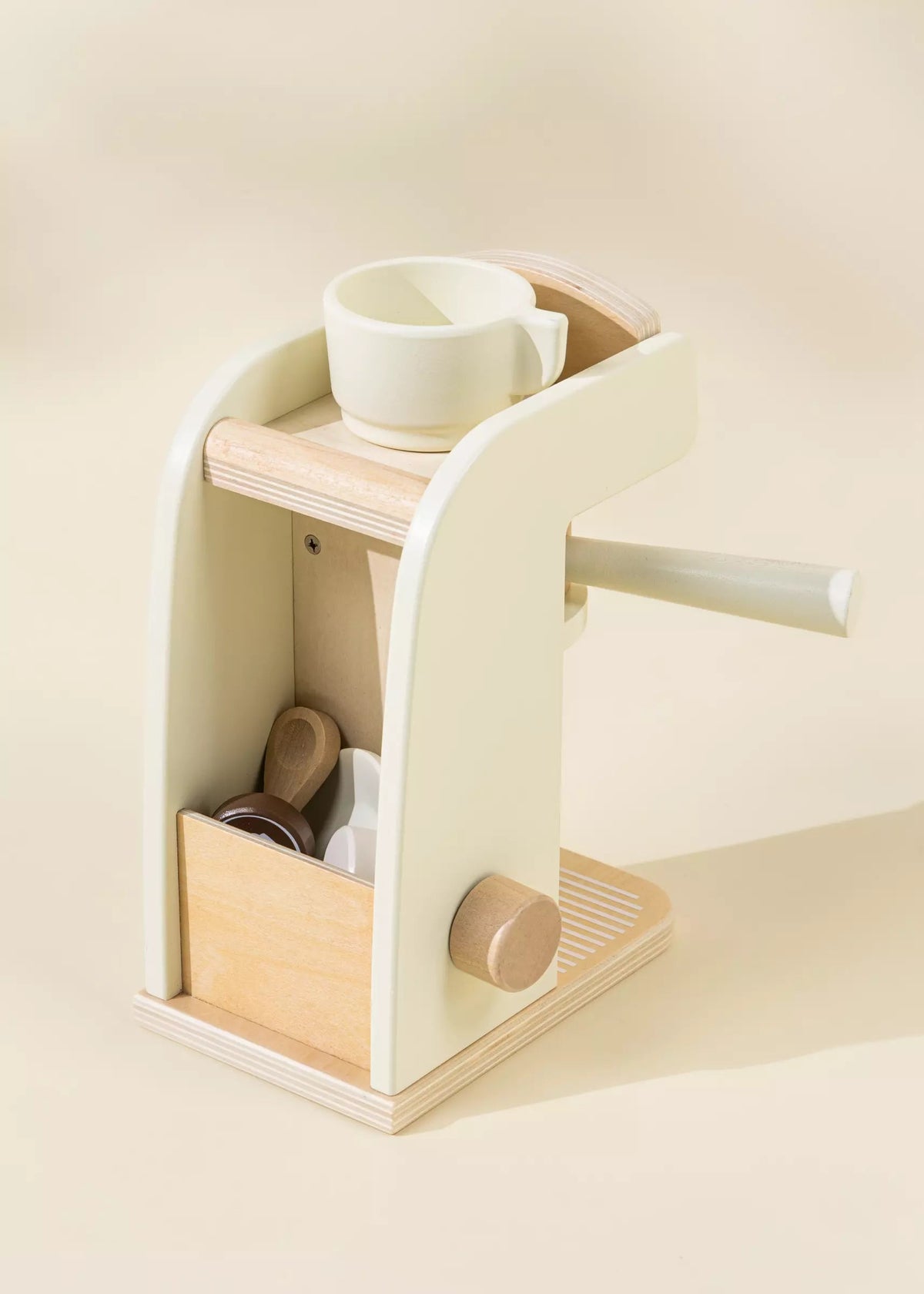 Wooden shelf with a white cup and other items on a light beige background