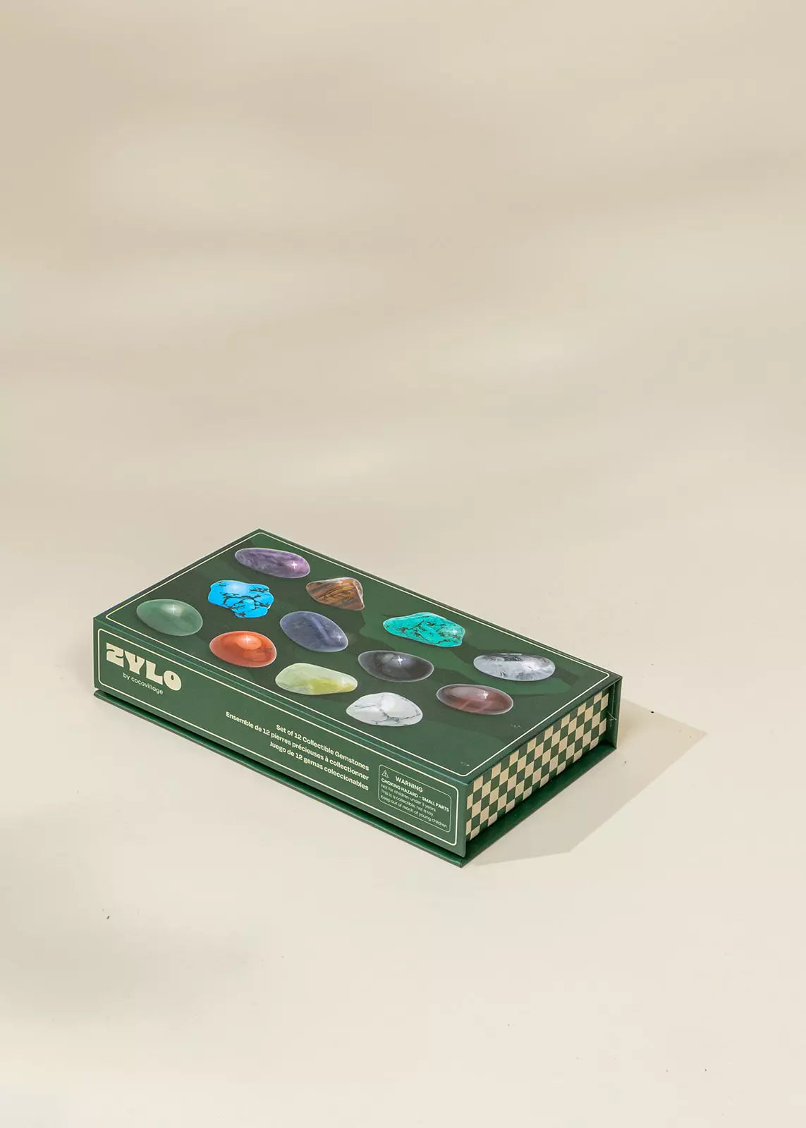Box of colorful stones with 'Zylo' branding on a beige background