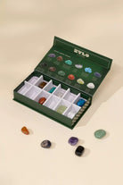 Open box of ZYLO gemstones with stones displayed on a beige background
