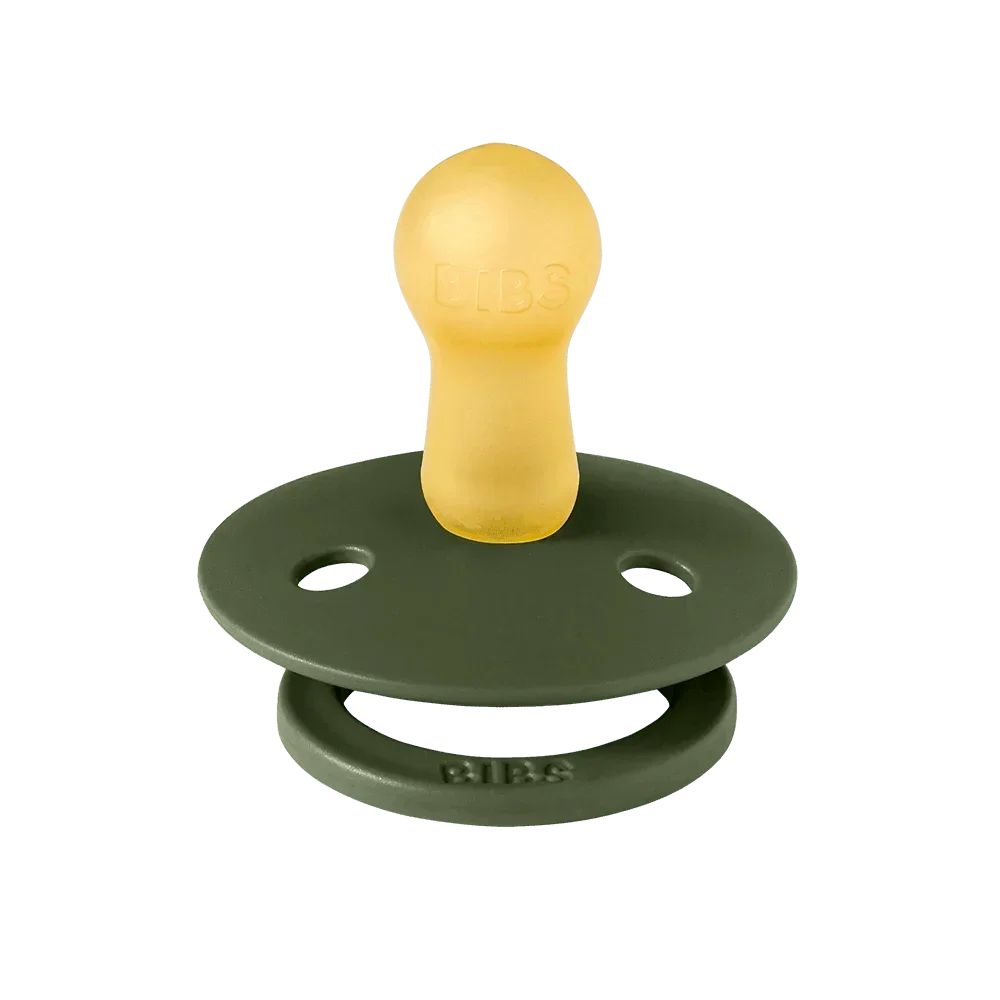 Green and yellow pacifier on a white background