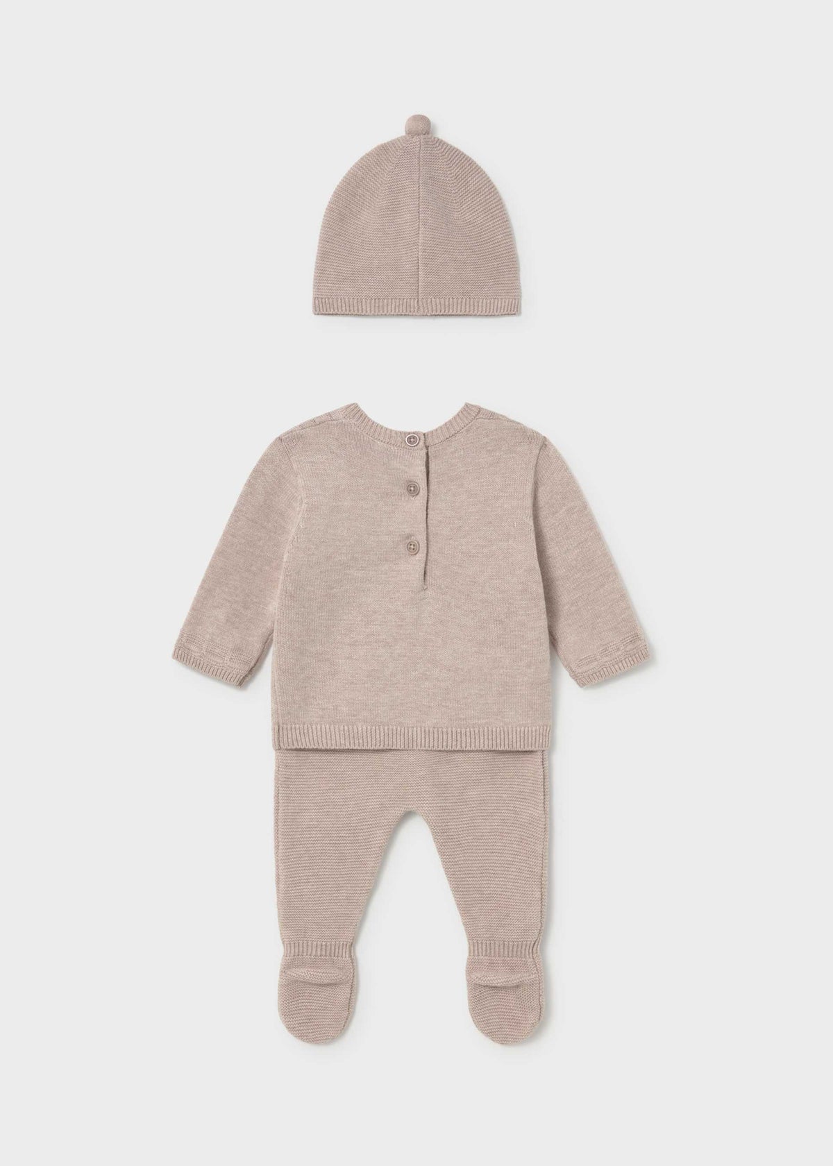 A baby knit three-piece outfit set in a soft dusty rose-beige color, including a long-sleeve henley top with three buttons, matching footed pants, and a knit bonnet hat, displayed on a light gray background.