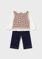 A toddler girl's two-piece outfit set featuring a white long-sleeve blouse under a beige leopard-print knit vest, paired with navy blue pants, shown against a light gray background.