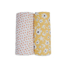 Two baby swaddle blankets, one with orange polka dots and the other with yellow floral pattern, on a white background.