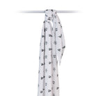 White scarf with black geometric pattern on a white background