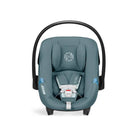 Blue baby car seat with black frame on a white background