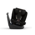 A black infant car seat with a side-impact protector and a light beige harness insert, shown from a side profile on a clean white background.