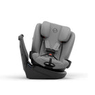 A gray and black infant car seat with a five-point harness, shown from a three-quarter side angle on a clean white background. The brand logo 'simbi' is visible on the headrest and the harness label.