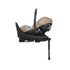 Baby car seat with beige cover and black base on a white background