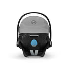 Baby car seat with gray canopy and black frame on a white background