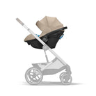 Baby stroller with beige canopy on a white background