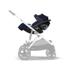 Baby stroller with black car seat attachment on a white background