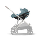 Baby stroller with blue car seat attachment on a white background