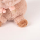 Close-up of a plush toy with a soft texture on a light background