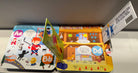 A colorful children's alphabet pop-up book displayed open, showing illustrated letters and 3D pop-up scenes including a superhero, a street scene, and a house.