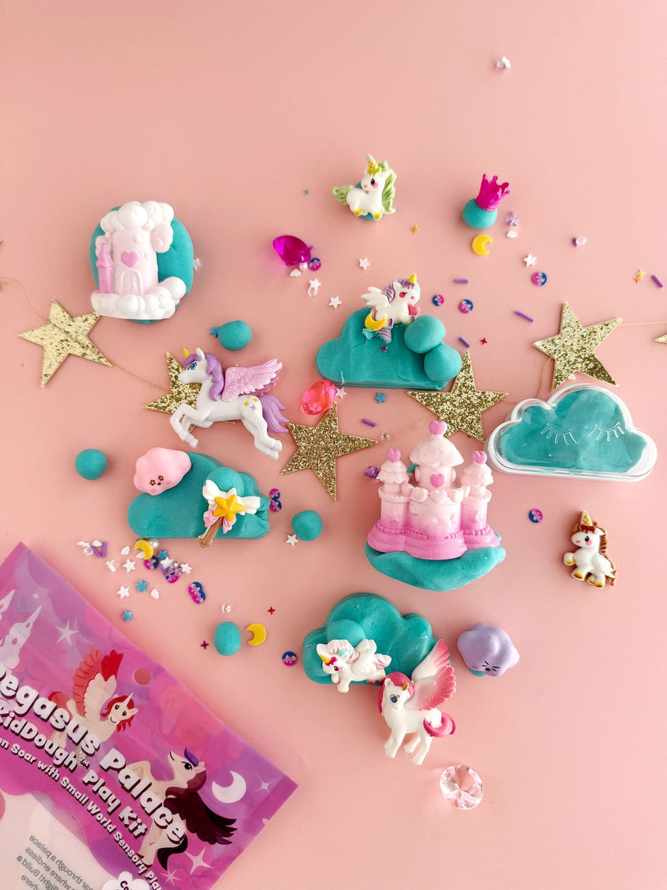 Unicorn-themed play set with accessories on a pink background