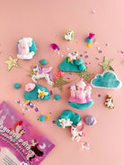 Unicorn-themed play set with accessories on a pink background