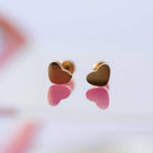 Heart-shaped earrings on a blurred background