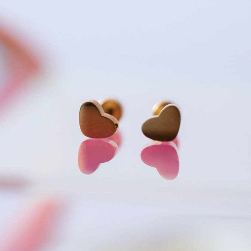 Heart-shaped earrings on a blurred background