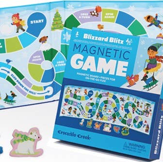 Blizzard Blitz Magnetic Game by Crocodile Creek, featuring a blue game box with colorful illustrated graphics and a matching game board in the background.