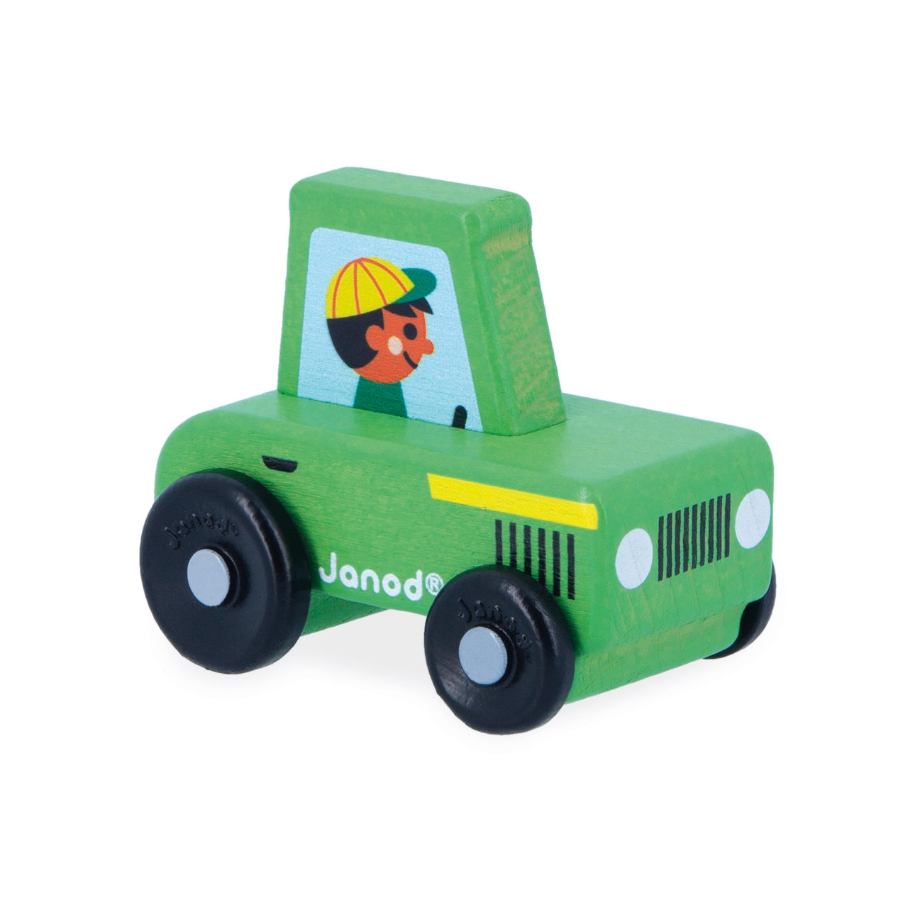 A wooden toy tractor by Janod in green, featuring black wheels, a yellow stripe, and a cartoon driver illustration in the window, set against a plain white background.