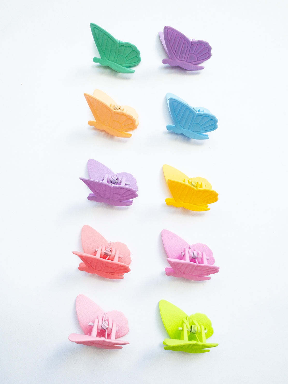Colorful butterfly-shaped clips on a white background