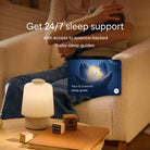 Person sitting on a couch with a baby sleep guide app displayed, promoting 24/7 sleep support.