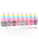 Set of colorful nail polish bottles with bows on a white background