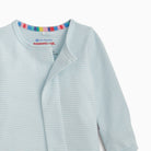A close-up of a baby long-sleeve wrap top in light blue and white stripes, featuring a colorful striped inner collar and a visible 'eco-friendly magnetic moms' brand label.