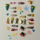 Collection of colorful hair clips and accessories on a light background