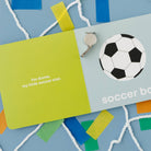 Children's book titled 'soccer boy' with a soccer ball illustration and a green card on a blue background.