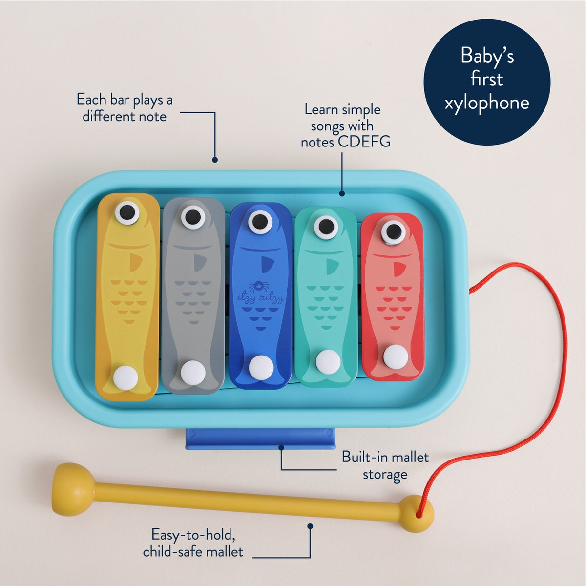 Baby xylophone with colorful bars and a mallet on a beige background