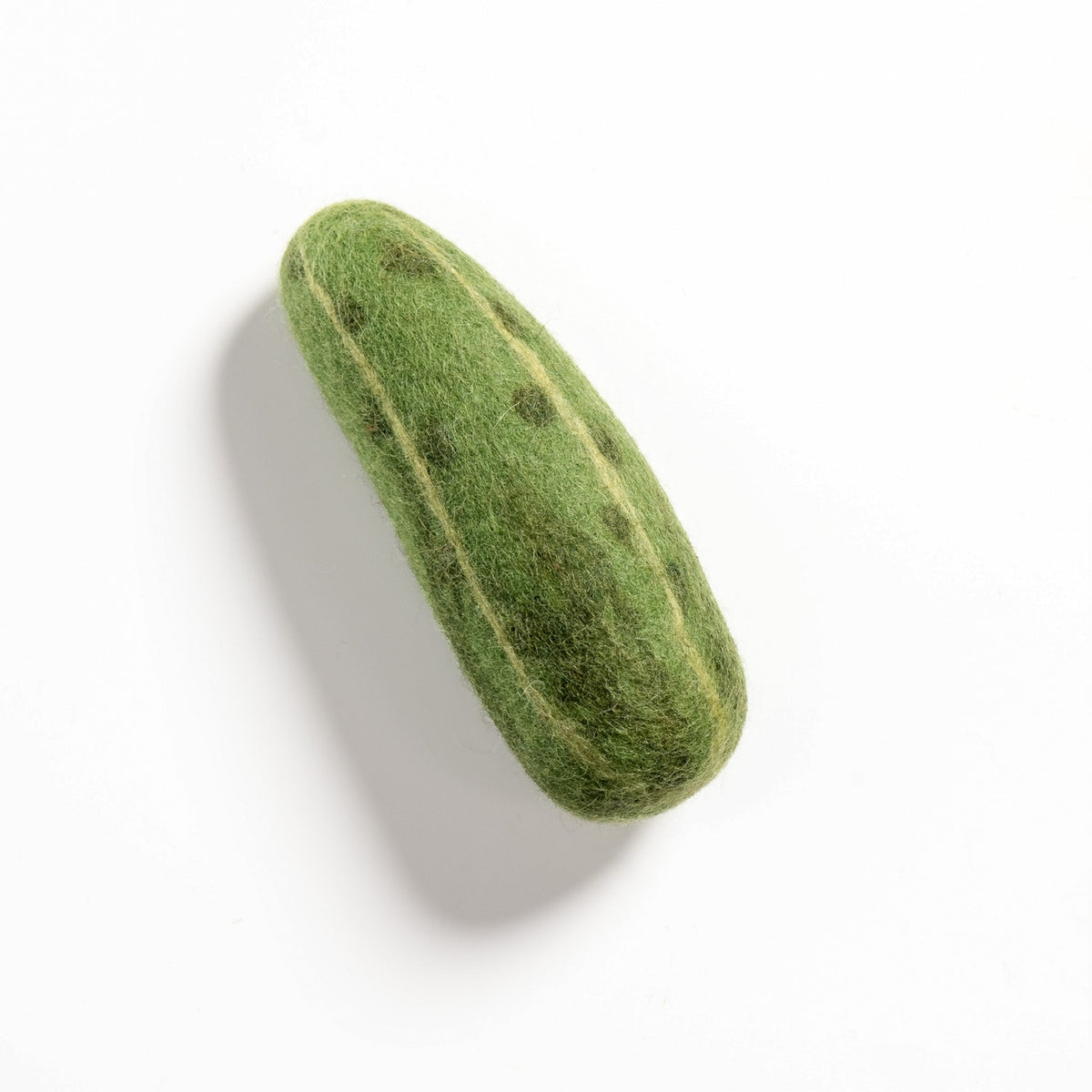 Green felted soap on a white background
