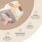 A plush baby sensory toy with a cream and gray fabric body, pink seashell details, and a white bird applique, shown on a beige infographic background with text highlighting handmade craftsmanship, soft plush texture, washability, and versatility.