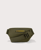Green waist bag with a yellow zipper on a light gray background