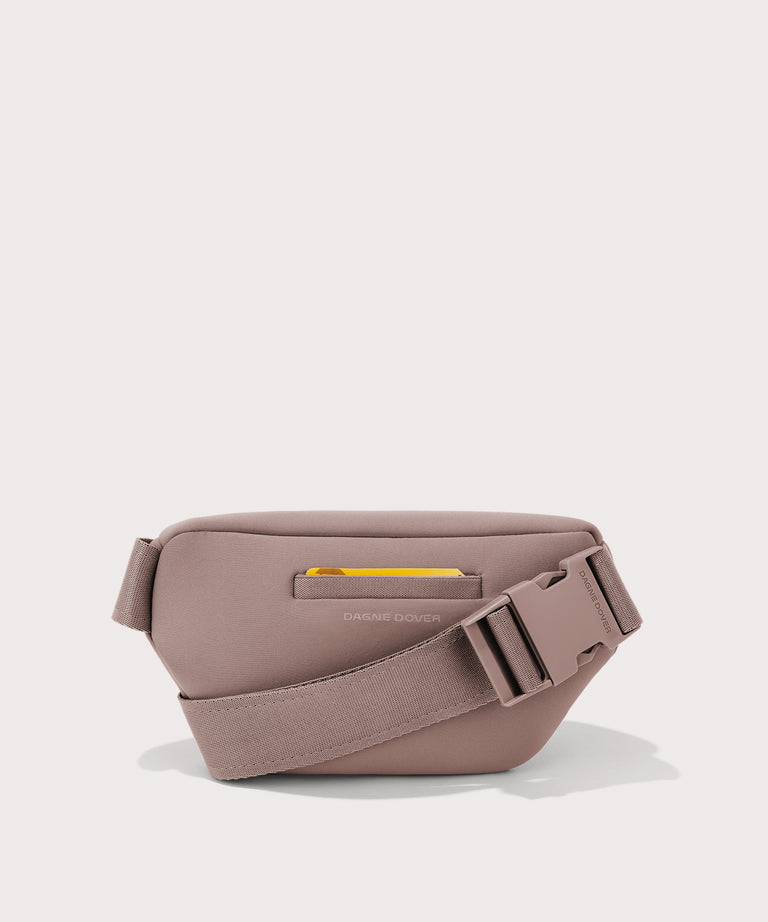 Grey waist bag with a yellow zipper on a light gray background
