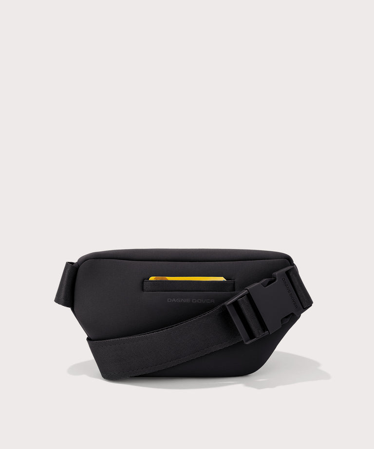 Black waist bag with a yellow zipper on a light gray background