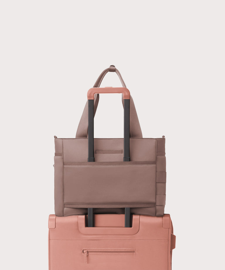 Stack of two bags, one brown and one pink, on a light gray background