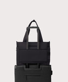 Black tote bag with multiple compartments on a light gray background
