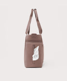 Brown leather bag with a tissue pocket on a light gray background